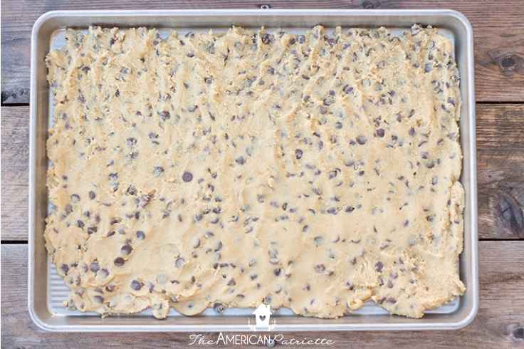 chocolate chip Texas cookies dough flattened and spread out on pan 